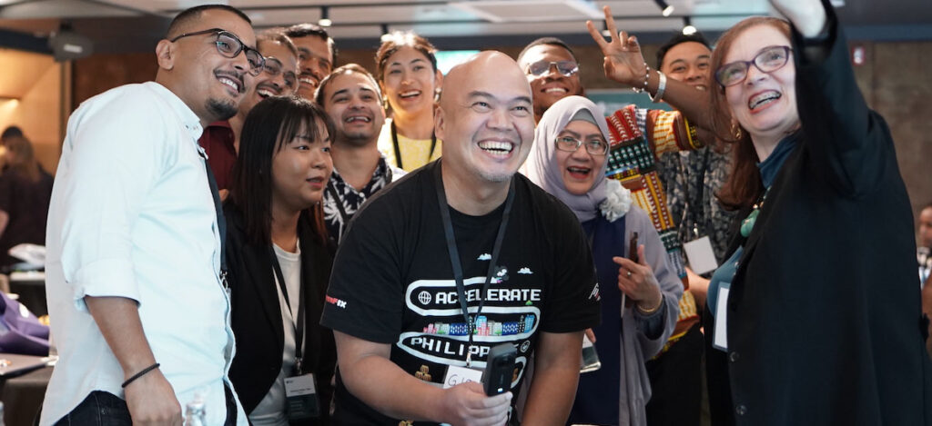 A group of Internet Society community fellows gather and pose for a selfie