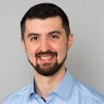 A man with moustaches and beard in blue shirt