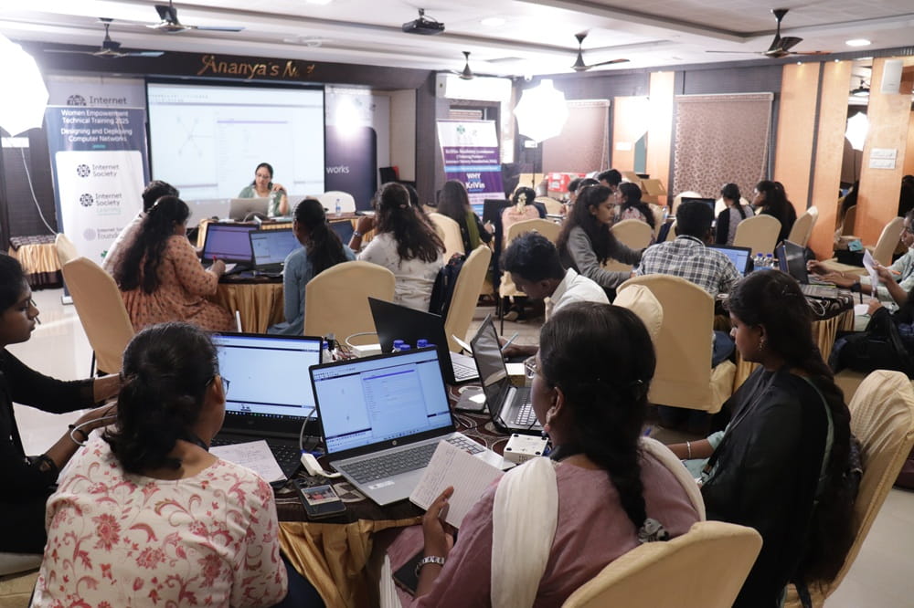 People gathered at the event sitting at the tables and working on laptops