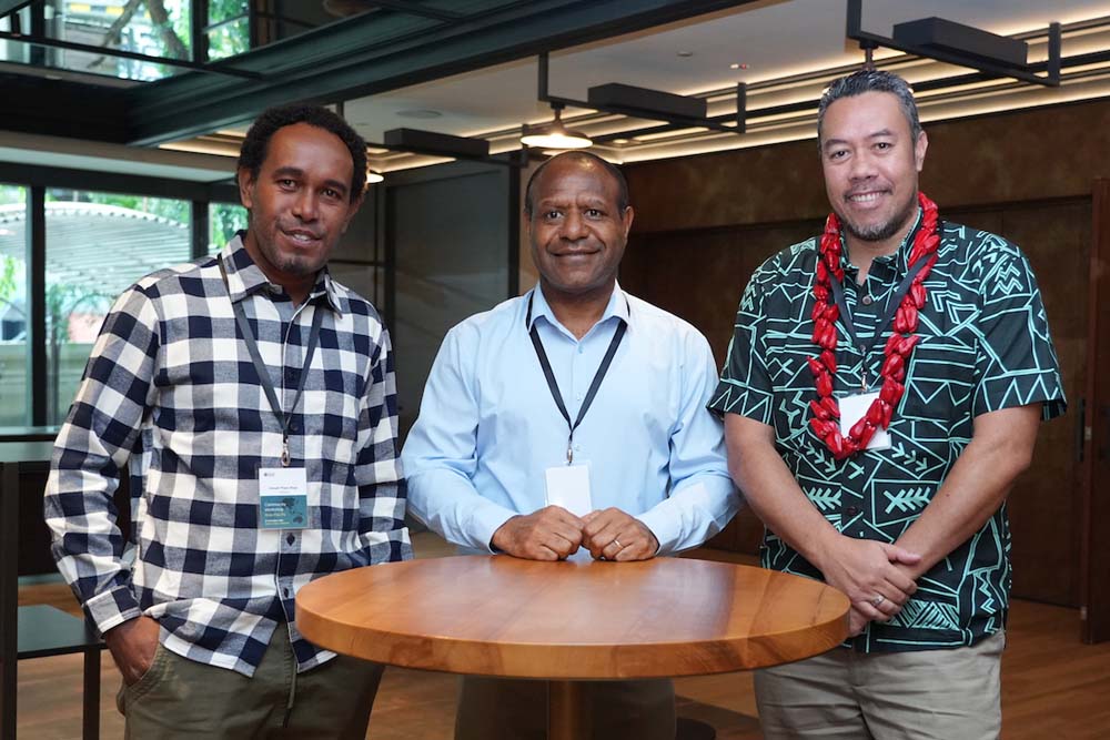 Three community fellows from Pacific Island nations stand together