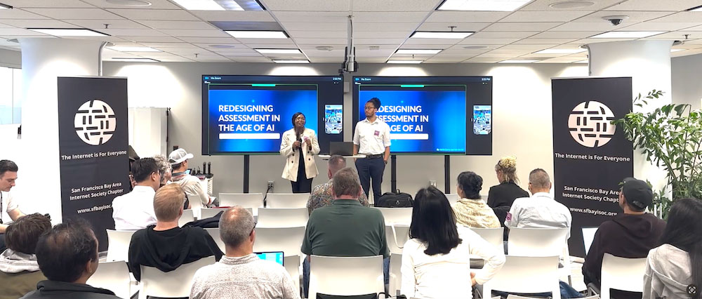 Two people stand and present to a seated group at AI Day SF
