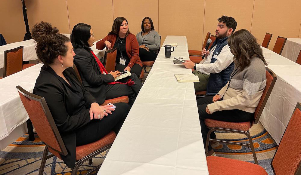 A small group discusses at a workshop