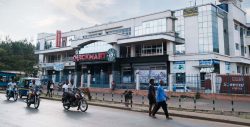People pass in front of the Tumaini Mall in Kisumu, Kenya.