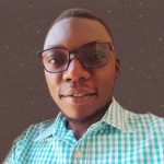 A man with glasses wearing a checkered shirt.