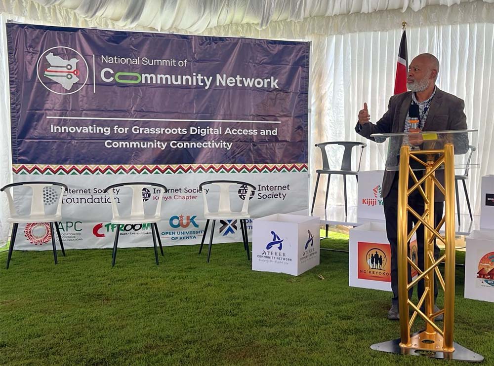 A man stands at a podium and speaks at the National Community Network Summit