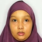 A woman with a purple headscarf