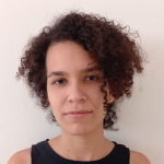 A woman with curly hair wearing a black top