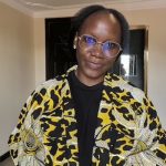 A woman in yellow and black cardigan