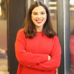 A woman in red shirt smiling