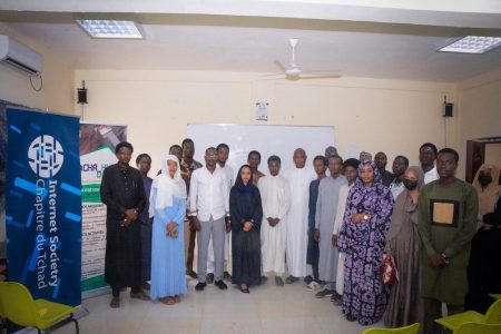 A group of people stand together next to an Internet Society Tchad Chapter sign