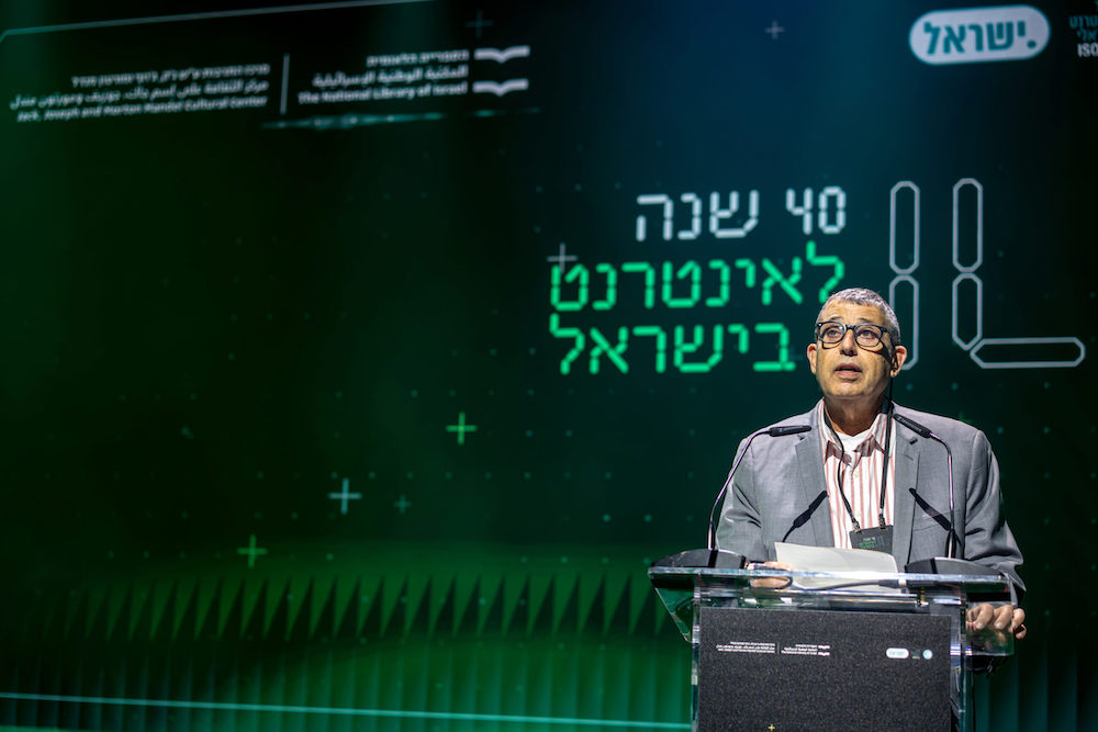 CEO of ISOC-IL, Yoram Hacohen, speaks at a podium