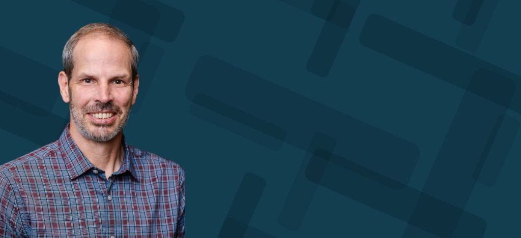 A headshot of Brian Haberman over a blue node background.