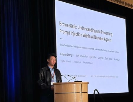 A man stands at a podium, delivering a presentation.
