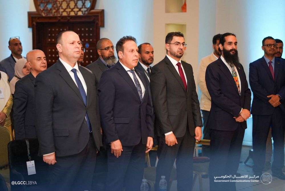 Several men in suits stand together and look in front of them.