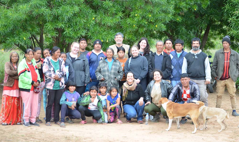 A group of people stands outside posing for a photo.