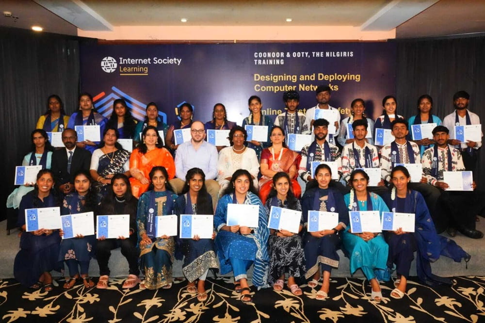 A diverse group of individuals poses with their certificates