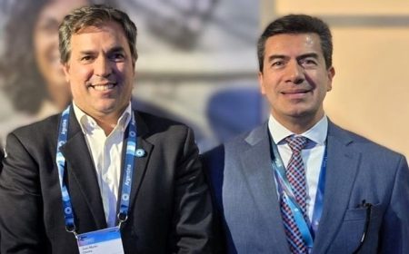 Two men in formal suits and ties standing side by side